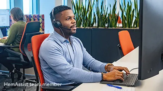 Portrayal of a man sitting at desk wearing a headset