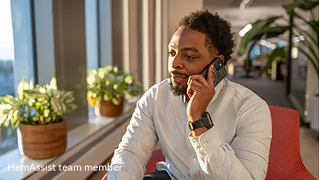 Portrayal of a man sitting speaking on a mobile phone
