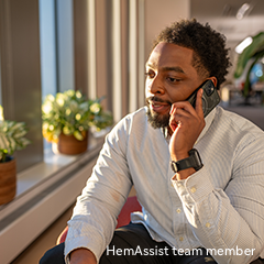Portrayal of a man sitting speaking on a mobile phone