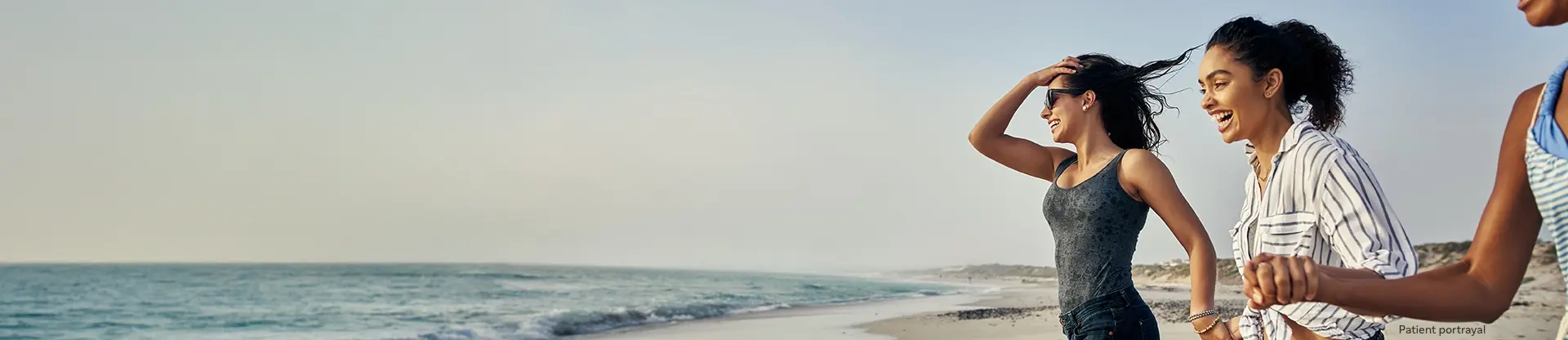 Patient portrayal of three young women on a beach